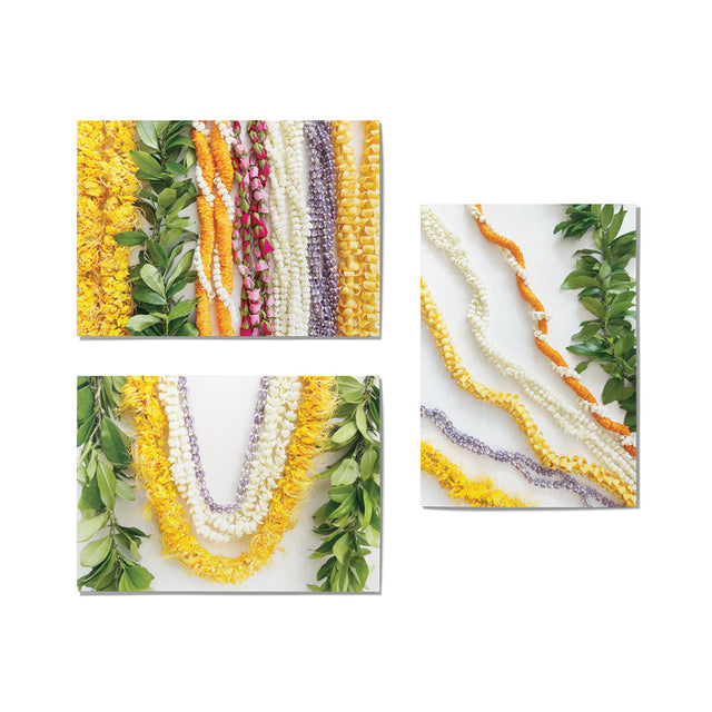 Colorful oflower lei with green leaves on a white background