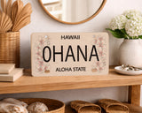 Decorative sign with 'Ohana and Aloha State' on a shelf with decorative items.