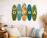 Decorative surfboard-shaped signs spelling 'OHANA' in a living room setting.
