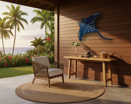 Outdoor patio with wooden chair, table, and decorative manta ray cutout against a wooden wall.